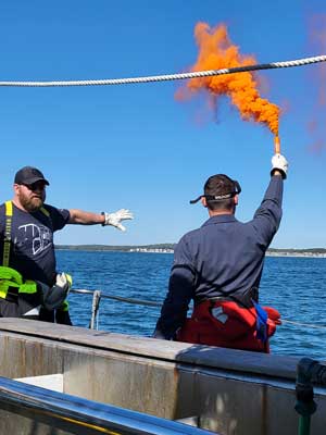 LTJG Jessurun demonstrates a smoke flare